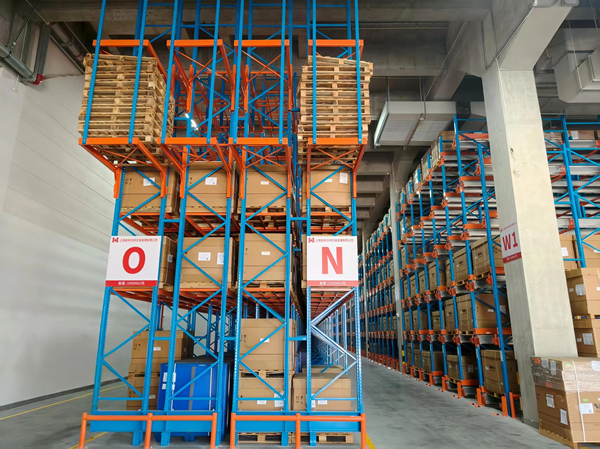 High-density drive-in pallet racking system loaded with goods in a warehouse. High-density drive-in pallet racking system loaded with goods in a warehouse.