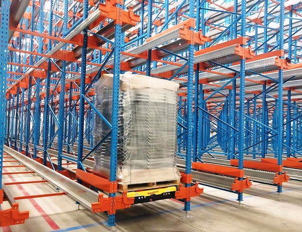 Radio shuttle pallet racking system transporting a wrapped pallet in a high-density warehouse. Radio shuttle pallet racking system transporting a wrapped pallet in a high-density warehouse.